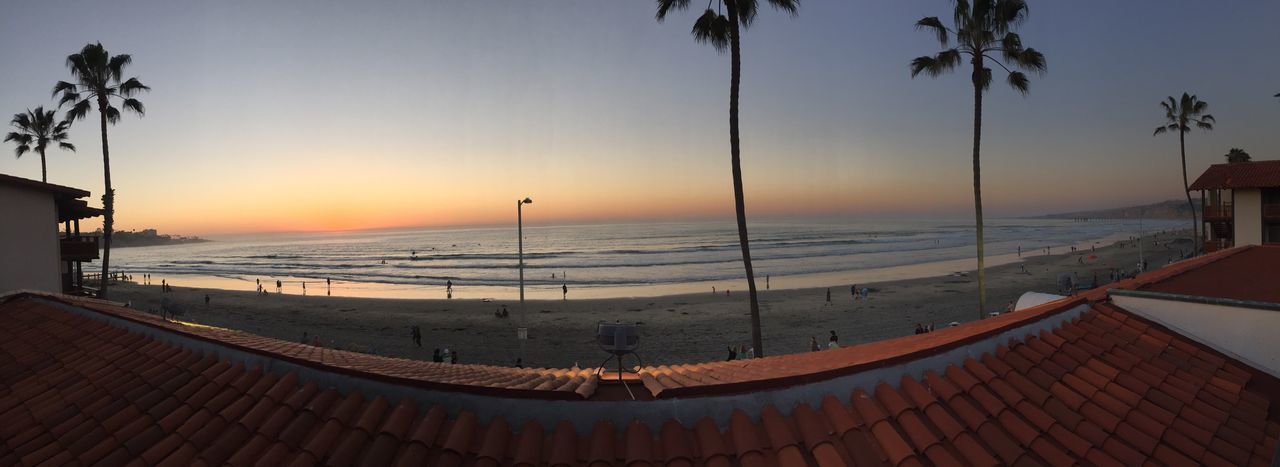 sea, horizon over water, sunset, water, beach, scenics, tranquil scene, beauty in nature, orange color, tranquility, clear sky, nature, shore, palm tree, idyllic, sky, sun, sunlight, incidental people, tree