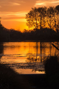 Scenic view of lake at sunset