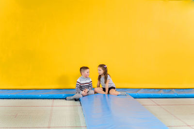 Rear view of people sitting in swimming pool