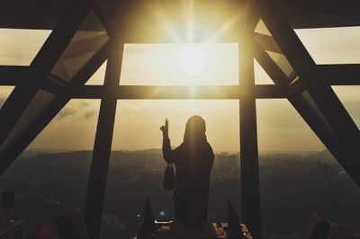 Silhouette of people standing on window