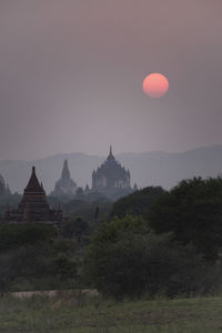 View of temple against clear sky at sunset