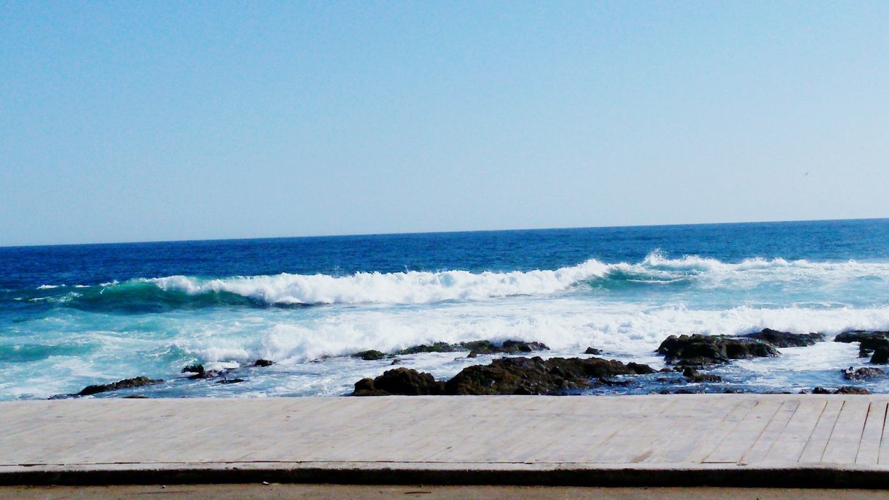 sea, water, horizon over water, wave, clear sky, beach, surf, copy space, shore, scenics, beauty in nature, nature, motion, tranquil scene, tranquility, blue, idyllic, sand, day, splashing