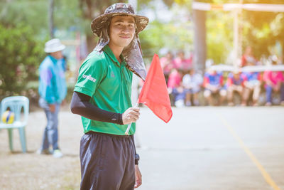 Portrait of woman wearing hat standing outdoors