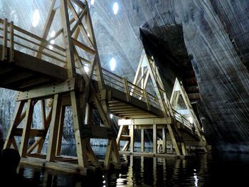 Low angle view of bridge over river against sky