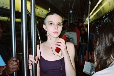 Portrait of young woman in bus