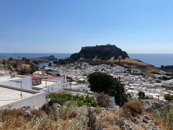 Townscape by sea against clear sky