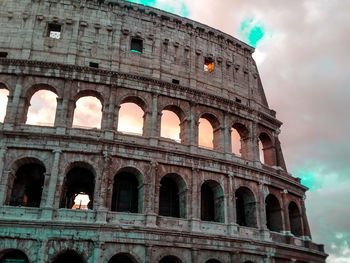 Low angle view of historical building against cloudy sky