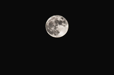 Low angle view of moon against clear sky at night