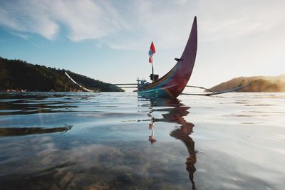 Surface level of boat on lake against sky