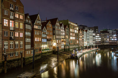 Buildings in city against sky at night