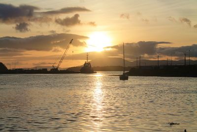 Silhouette of sailboats in sea during sunset