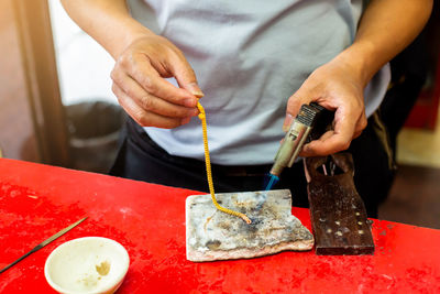 Midsection of man preparing food on table