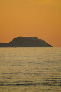 Scenic view of sea against orange sky