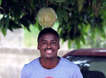 Portrait of smiling young man standing outdoors