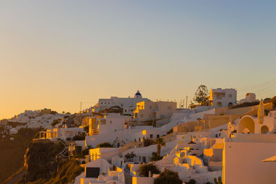 Buildings in city against sky during sunset