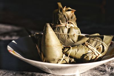 Close-up of food wrapped in leaf on plate at table