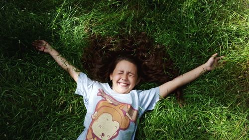 Portrait of happy girl playing on field