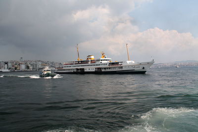 Ship sailing on sea against sky