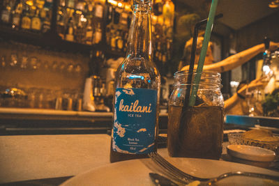 Close-up of wine bottles on table at restaurant