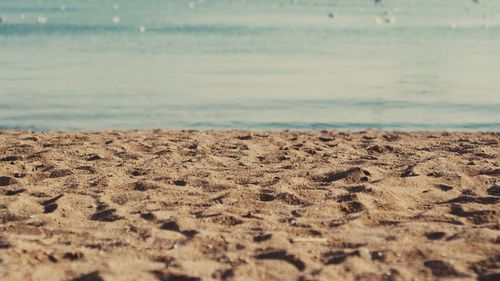 Close-up of sand on beach against sky