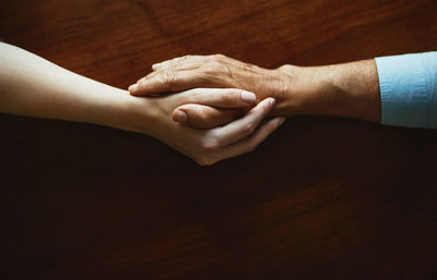 Low section of woman with hands on table