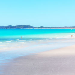 Scenic view of beach against clear blue sky