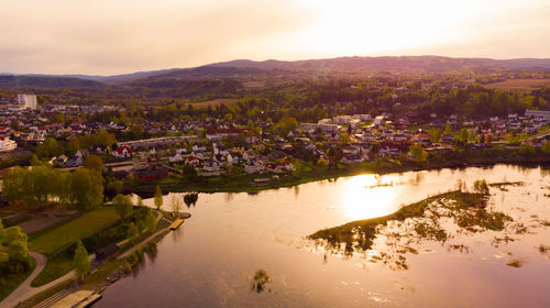 Aerial view of river and cityscape against sky