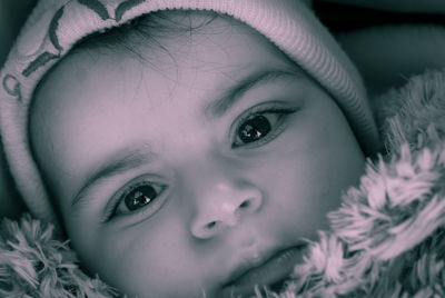 Close-up portrait of baby girl wearing knit hat