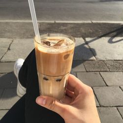 Cropped image of hand holding coffee cup