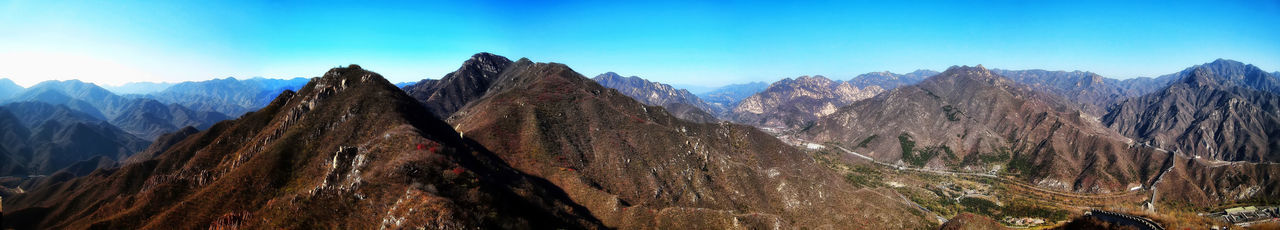 Panoramic view of snowcapped mountains against blue sky