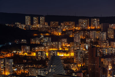 High angle view of illuminated buildings in city at night