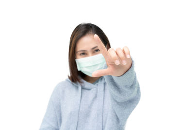 Portrait of beautiful woman against white background