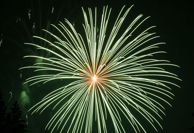 Low angle view of firework display at night