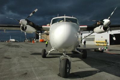 Airplane on runway against sky