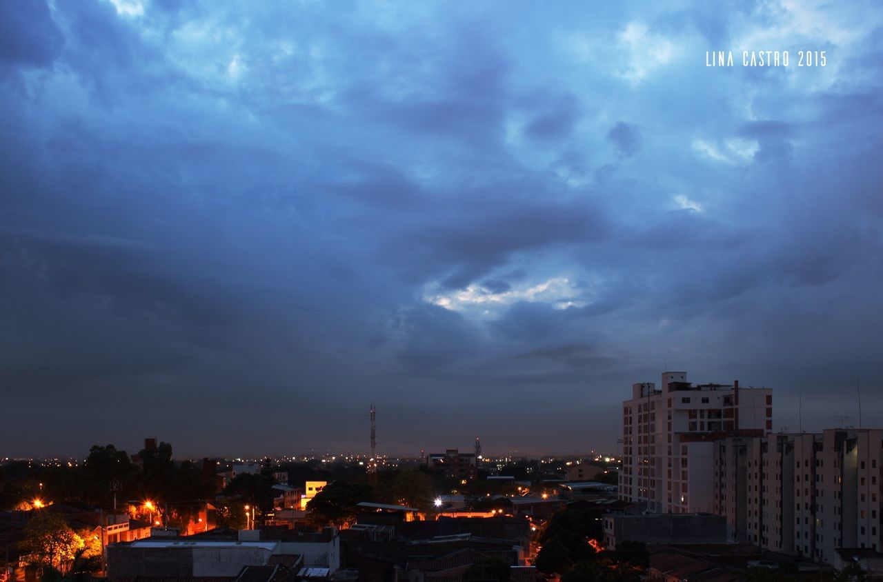 building exterior, city, architecture, cityscape, sky, built structure, illuminated, cloud - sky, night, residential district, cloudy, residential building, storm cloud, dusk, residential structure, crowded, weather, city life, dramatic sky, cloud