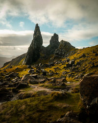 Old man of storr rock formations with golden light and dramatic sky on isle of skye scotland.