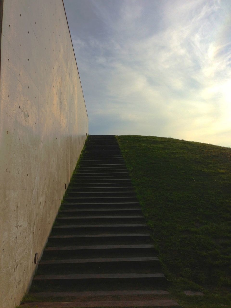 sky, the way forward, built structure, cloud - sky, architecture, diminishing perspective, cloudy, cloud, landscape, steps, grass, tranquility, no people, day, field, outdoors, nature, vanishing point, low angle view, building exterior