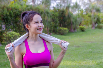 Portrait of smiling woman standing on field