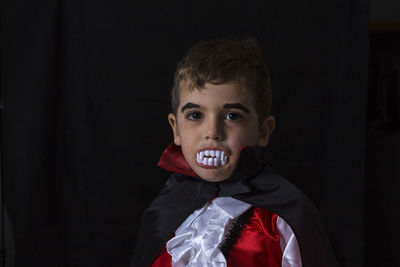 Close-up portrait of boy in vampire costume