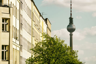 Low angle view of trees and buildings against sky