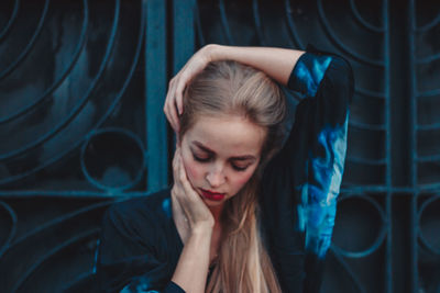 Young woman with hand in hair