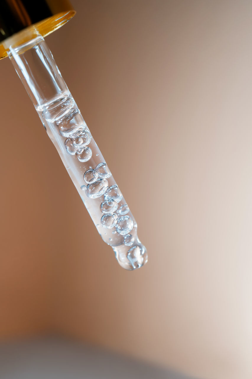 CLOSE-UP OF ICE CRYSTALS ON TABLE AGAINST GRAY BACKGROUND