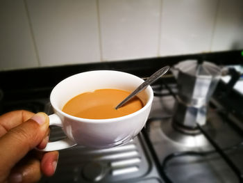 Midsection of person holding tea cup