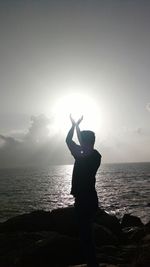 Full length of man standing at sea against sky