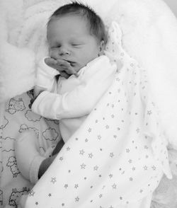 High angle view of baby sleeping on bed