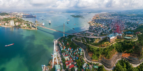 High angle view of buildings by sea against sky