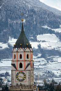 Traditional building against mountain in winter