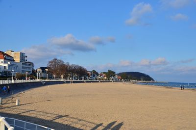 Scenic view of beach against blue sky