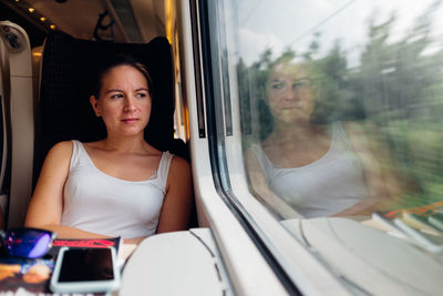 Rear view of woman sitting in train