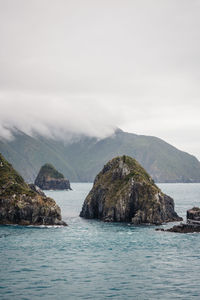 Scenic view of sea and mountains against sky